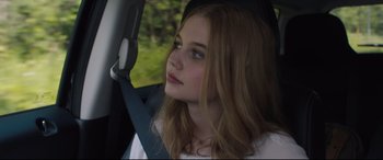 Movie still from “Every Day” (2018), directed by Michael Sucsy – A young woman sitting in a car with her hand on the steering wheel; Close Up shot, Low angle
