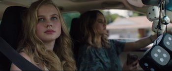 Movie still from “Every Day” (2018), directed by Michael Sucsy – Two young women sitting in the back seat of a car; Close Up shot, Over the shoulder angle