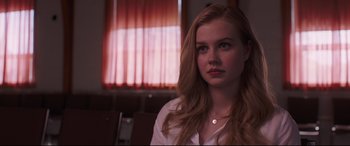 Movie still from “Every Day” (2018), directed by Michael Sucsy – A woman sitting in front of a window looking at the camera; Close Up shot, Over the shoulder angle