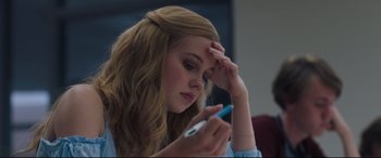Movie still from “Every Day” (2018), directed by Michael Sucsy – A woman holding a cell phone in one hand and her hand on her forehead; Close Up shot, High angle