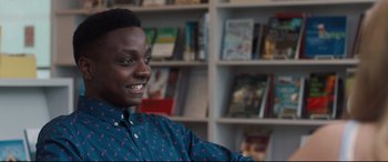 Movie still from “Every Day” (2018), directed by Michael Sucsy – A man sitting in front of a book shelf; Close Up shot, Over the shoulder angle