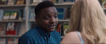 Movie still from “Every Day” (2018), directed by Michael Sucsy – A man in a blue shirt is talking to a woman in front of a book shelf; Close Up shot, Over the shoulder angle