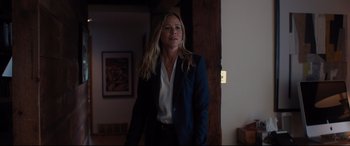 Movie still from “Every Day” (2018), directed by Michael Sucsy – A woman in a suit standing in front of a door; Medium shot, Over the shoulder angle