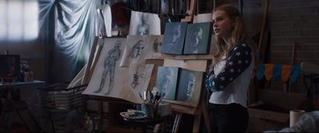 Movie still from “Every Day” (2018), directed by Michael Sucsy – A woman standing in front of a few paintings; Medium shot, Over the shoulder angle