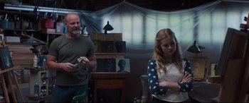 Movie still from “Every Day” (2018), directed by Michael Sucsy – A man and a woman standing next to each other in a room; Medium shot, Over the shoulder angle