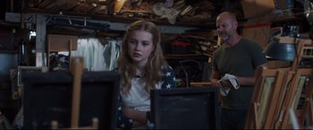 Movie still from “Every Day” (2018), directed by Michael Sucsy – A young girl sitting in front of computer monitors; Medium shot, Over the shoulder angle