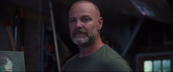 Movie still from “Every Day” (2018), directed by Michael Sucsy – A man with a shaved head and a beard; Close Up shot, Low angle
