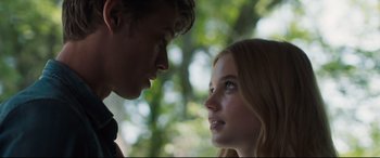 Movie still from “Every Day” (2018), directed by Michael Sucsy – A man and a woman face to face in front of trees; Close Up shot, Low angle