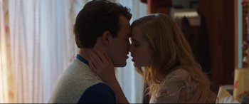 Movie still from “Every Day” (2018), directed by Michael Sucsy – A man and a woman kissing in front of a window; Close Up shot, Low angle