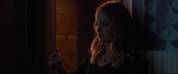 Movie still from “Every Day” (2018), directed by Michael Sucsy – A woman holding a cell phone while standing in a dark room; Close Up shot, Over the shoulder angle
