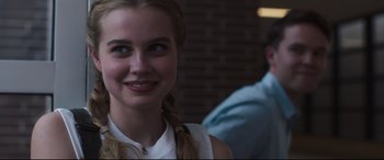 Movie still from “Every Day” (2018), directed by Michael Sucsy – A woman with a braid is smiling for the camera; Close Up shot, Over the shoulder angle
