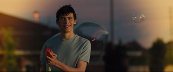 Movie still from “Every Day” (2018), directed by Michael Sucsy – A man holding a tennis racket in his hand; Medium shot, Over the shoulder angle