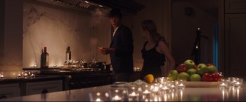 Movie still from “Every Day” (2018), directed by Michael Sucsy – A man and a woman standing in front of a stove; Medium shot, Low angle