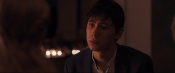 Movie still from “Every Day” (2018), directed by Michael Sucsy – A young man in a suit looking to his left; Close Up shot, Over the shoulder angle