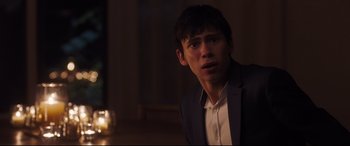 Movie still from “Every Day” (2018), directed by Michael Sucsy – A man in a suit and tie looking at the camera; Close Up shot, Over the shoulder angle