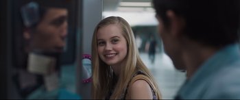 Movie still from “Every Day” (2018), directed by Michael Sucsy – A young woman smiles brightly as she looks into a mirror; Close Up shot, Over the shoulder angle