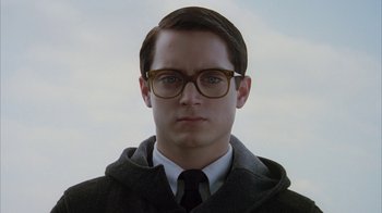 Movie still from “Everything Is Illuminated” (2005), directed by Liev Schreiber – A man wearing glasses and a hooded jacket; Close Up shot, Low angle