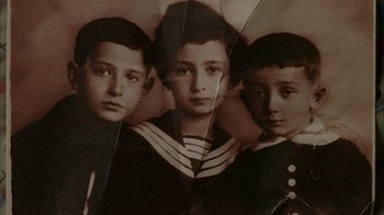 Movie still from “Everything Is Illuminated” (2005), directed by Liev Schreiber – Three young boys are posing for a picture; Close Up shot, Overhead angle