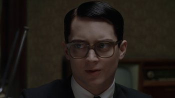 Movie still from “Everything Is Illuminated” (2005), directed by Liev Schreiber – A man wearing glasses and a suit and tie; Close Up shot, Over the shoulder angle
