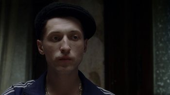 Movie still from “Everything Is Illuminated” (2005), directed by Liev Schreiber – A man with a hat and a mustache; Close Up shot, Over the shoulder angle