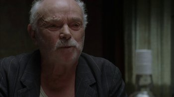 Movie still from “Everything Is Illuminated” (2005), directed by Liev Schreiber – An older man with a mustache and a beard; Close Up shot, Over the shoulder angle