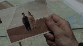 Movie still from “Everything Is Illuminated” (2005), directed by Liev Schreiber – A person holding an old photo of a man and a woman; Extreme Close Up shot, Overhead angle