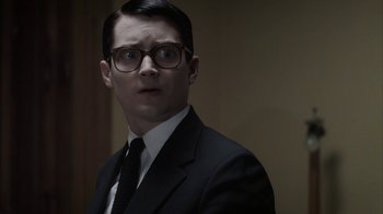 Movie still from “Everything Is Illuminated” (2005), directed by Liev Schreiber – A man in a suit and tie wearing glasses; Close Up shot, Over the shoulder angle