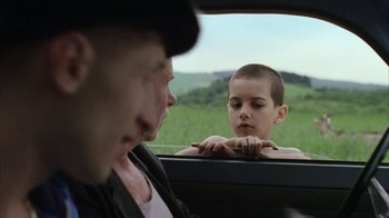 Movie still from “Everything Is Illuminated” (2005), directed by Liev Schreiber – A man and a boy looking out of a car window; Close Up shot, Over the shoulder angle