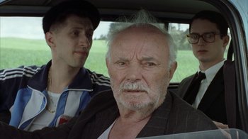 Movie still from “Everything Is Illuminated” (2005), directed by Liev Schreiber – An old man with a beard and a mustache in a car; Close Up shot, Over the shoulder angle