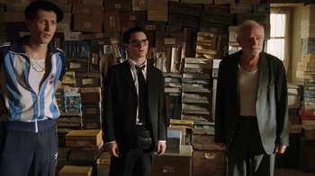 Movie still from “Everything Is Illuminated” (2005), directed by Liev Schreiber – A man standing in front of a wall full of boxes; Wide shot, Low angle