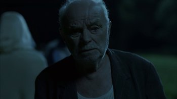 Movie still from “Everything Is Illuminated” (2005), directed by Liev Schreiber – An old man with a white beard is looking at the camera; Close Up shot, Over the shoulder angle