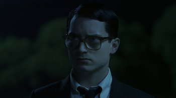 Movie still from “Everything Is Illuminated” (2005), directed by Liev Schreiber – A man wearing glasses and a suit and tie; Close Up shot, Low angle