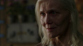 Movie still from “Everything Is Illuminated” (2005), directed by Liev Schreiber – An older woman with white hair looking at the camera; Close Up shot, Over the shoulder angle