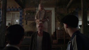 Movie still from “Everything Is Illuminated” (2005), directed by Liev Schreiber – An older man standing in front of two young people; Medium shot, Over the shoulder angle