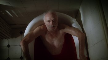 Movie still from “Everything Is Illuminated” (2005), directed by Liev Schreiber – An old man is sitting in a bathtub; Medium shot, Overhead angle