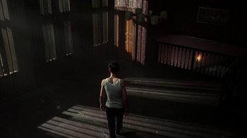 Movie still from “Everything Is Illuminated” (2005), directed by Liev Schreiber – A woman is standing in the sunlight on the steps; Wide shot, Low angle