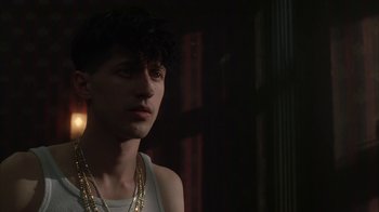 Movie still from “Everything Is Illuminated” (2005), directed by Liev Schreiber – A young man wearing a white tank top and gold chains; Close Up shot, Low angle