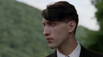 Movie still from “Everything Is Illuminated” (2005), directed by Liev Schreiber – A man in a suit and tie looking to his left; Close Up shot, Low angle