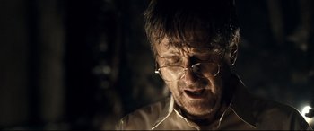 Movie still from “Evil Dead” (2013), directed by Fede Alvarez – An older man wearing glasses and a white shirt; Close Up shot, Over the shoulder angle