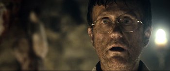 Movie still from “Evil Dead” (2013), directed by Fede Alvarez – A person wearing glasses; Close Up shot, Low angle