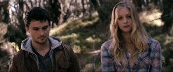 Movie still from “Evil Dead” (2013), directed by Fede Alvarez – A woman standing next to a man wearing a jacket; Close Up shot, Over the shoulder angle
