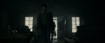 Movie still from “Evil Dead” (2013), directed by Fede Alvarez – A group of people standing around in a room; Wide shot, Over the shoulder angle