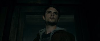 Movie still from “Evil Dead” (2013), directed by Fede Alvarez – A man with a beard is looking up at the ceiling; Close Up shot, Low angle