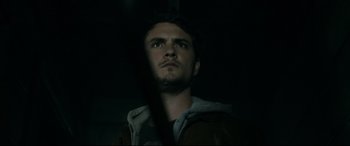 Movie still from “Evil Dead” (2013), directed by Fede Alvarez – A young man looking up into the dark; Close Up shot, Low angle