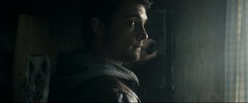 Movie still from “Evil Dead” (2013), directed by Fede Alvarez – A young man in a hooded jacket looking at the camera; Close Up shot, Over the shoulder angle