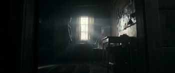 Movie still from “Evil Dead” (2013), directed by Fede Alvarez – Two people are standing in a dark room; Wide shot, Low angle