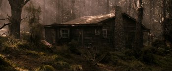 Movie still from “Evil Dead” (2013), directed by Fede Alvarez – An old log cabin in the middle of the woods; Extreme Wide shot, High angle