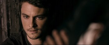 Movie still from “Evil Dead” (2013), directed by Fede Alvarez – A man's face in the dark; Close Up shot, Over the shoulder angle