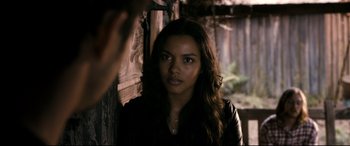 Movie still from “Evil Dead” (2013), directed by Fede Alvarez – A woman in a leather jacket looking at the camera; Close Up shot, Over the shoulder angle