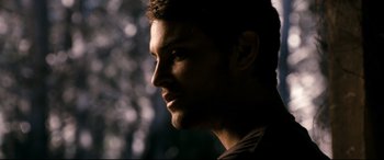 Movie still from “Evil Dead” (2013), directed by Fede Alvarez – A man's face in the dark; Close Up shot, Over the shoulder angle